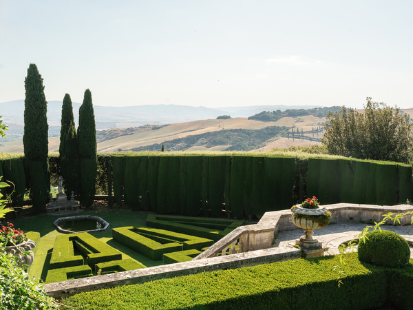 Renaissance gardens at La Foce overlooking the Tuscan countryside during an elegant Italian estate wedding