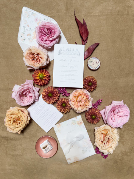 Elegant wedding stationery flat lay with pastel roses and floral details for a La Foce destination wedding in Tuscany