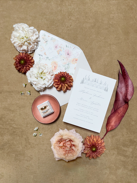 Custom wedding stationery with rings and soft floral accents for a refined La Foce wedding in Tuscany