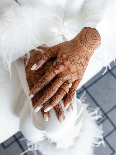 Close-up of intricate mehndi henna on the bride’s hands during a three-day Indian wedding in Athens at Island Art & Taste
