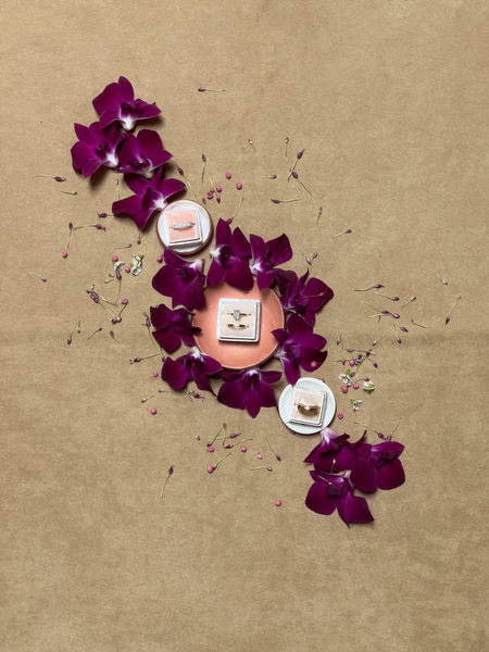 Bridal perfume and styling details surrounded by deep burgundy orchids for an elegant Italian estate wedding