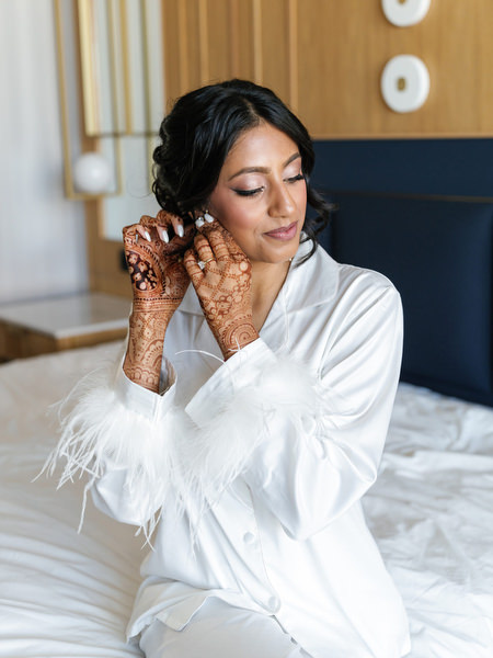 Bride adjusting earrings before the Hindu ceremony at Island Resort The Residence during an Athens Riviera Indian wedding