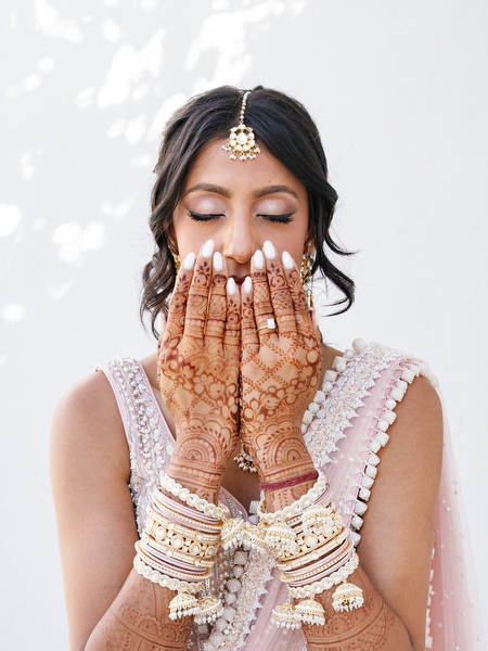 Bride showing detailed henna before her Island Resort The Residence Indian wedding ceremony