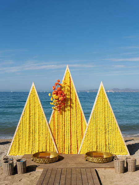Yellow Haldi decor setup on the beach at the Athenian Riviera