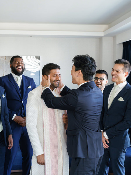 Emotional moment as the groom’s stole is adjusted before the ceremony at Grand Hyatt Athens, Greece
