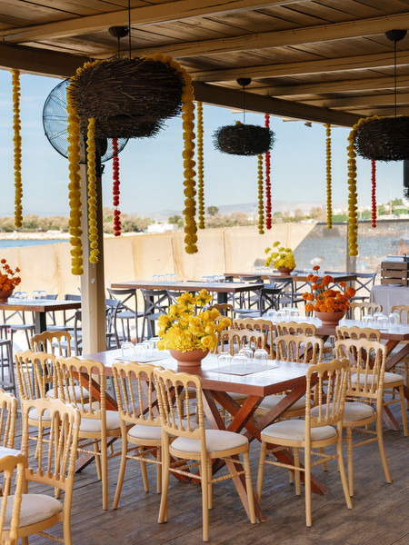 Beachfront Haldi ceremony table setup overlooking the sea in Athens