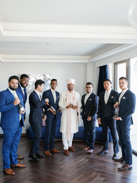 Group portrait of groom and friends during a three-day Indian wedding celebration at Grand Hyatt Athens
