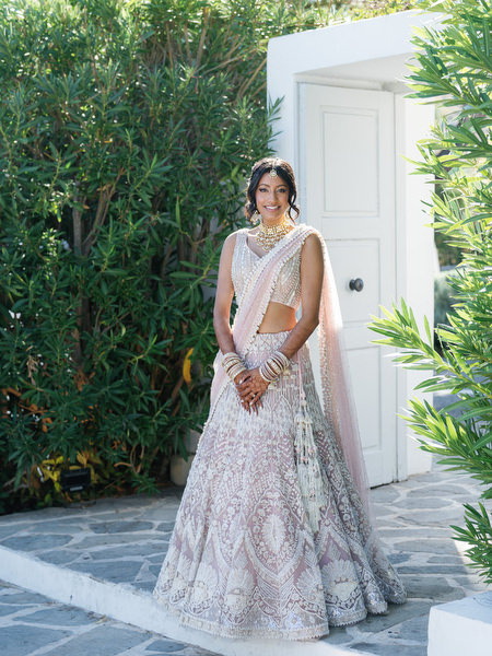 Bride portrait in blush lehenga framed by Mediterranean greenery at Island Resort the Residence