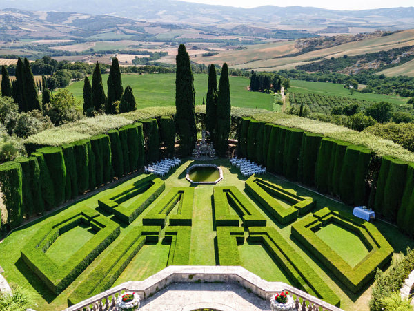 Ceremony setup in the formal Renaissance gardens at La Foce overlooking the Tuscan countryside