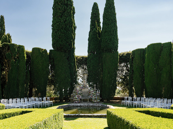 Cypress trees framing the ceremony altar at La Foce wedding in Tuscany