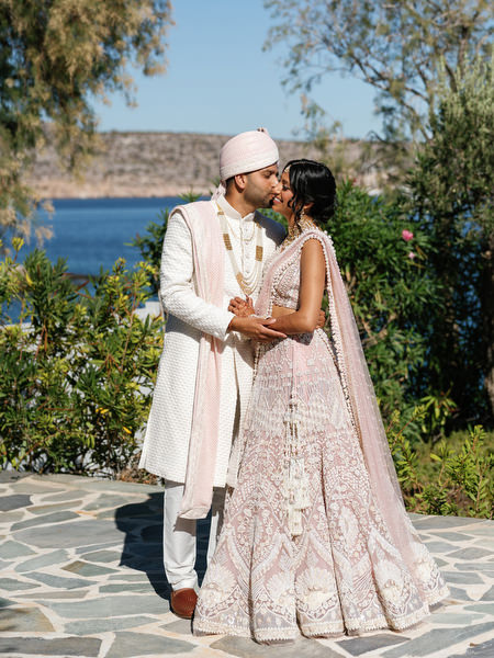 Bride and groom embracing during their luxury Indian destination wedding in Athens at Island Resort