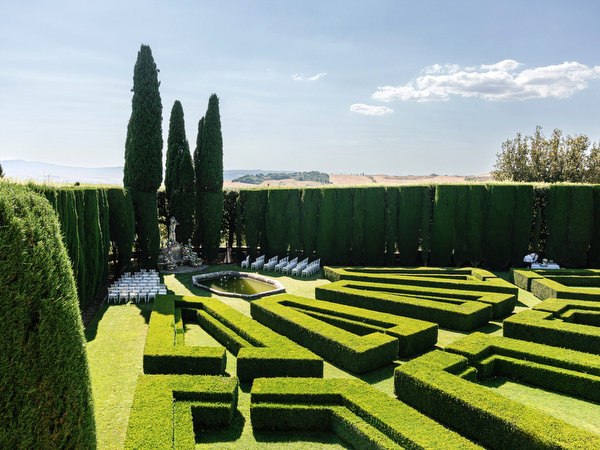 Symmetrical hedge maze gardens at La Foce estate in the rolling hills of Tuscany