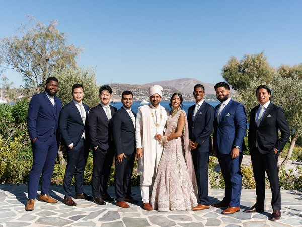 Bride and groom with groomsmen during their Athens Riviera Indian wedding at Island Resort