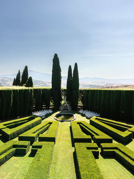 Symmetrical hedge maze gardens at La Foce estate in the rolling hills of Tuscany