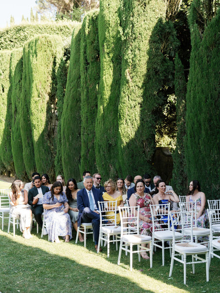 Wedding guests seated in the gardens awaiting ceremony at La Foce in Tuscany