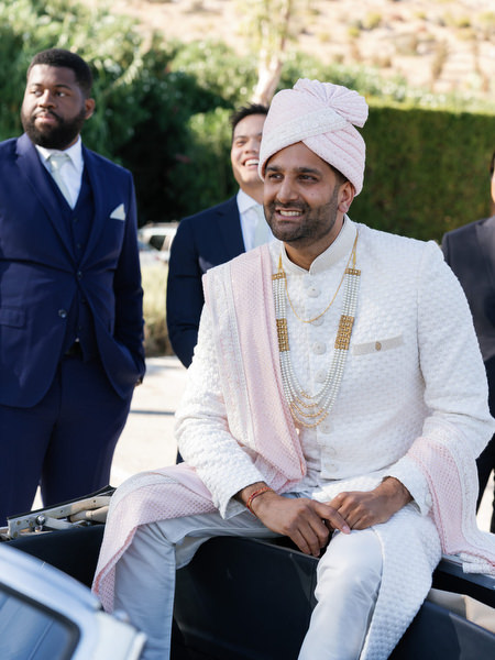 Portrait of groom seated on classic car before the ceremony at Island Resort the Residence on the Athens Riviera