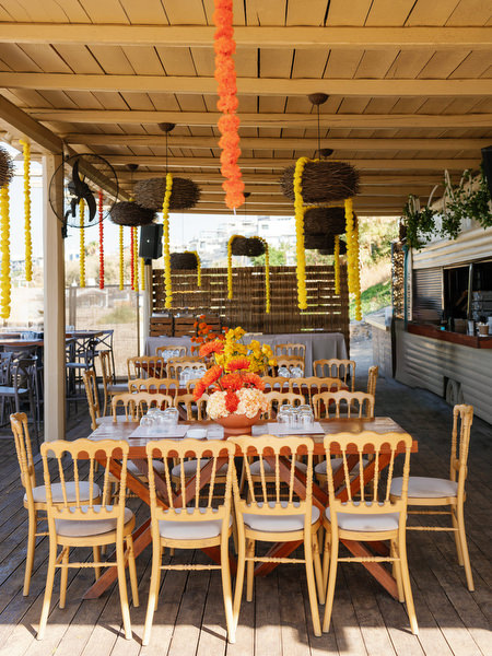 Beachside Haldi celebration setup with yellow decor in Athens
