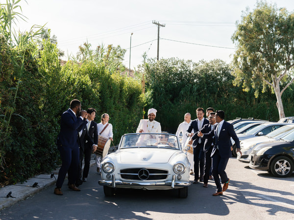 Wedding party gathering around vintage car before the baraat at Island Resort the Residence