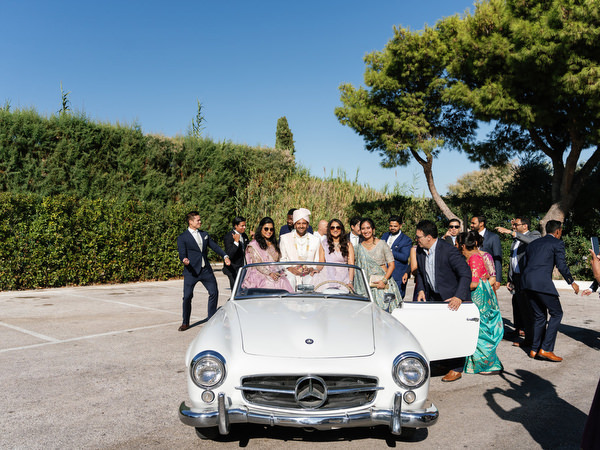 Vintage Mercedes surrounded by guests during an Athens Riviera Indian wedding celebration