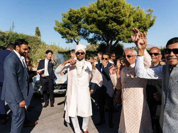 Groom leading the baraat celebration at Island Resort the Residence on the Athens Riviera
