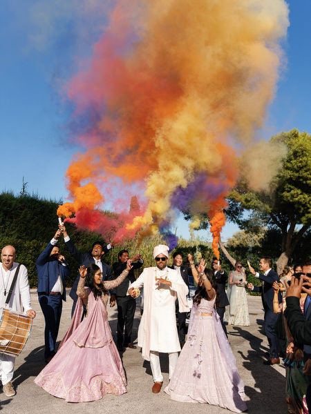 Colorful smoke flares during the baraat procession at a luxury Indian wedding at Island Resort the Residence on the Athens Riviera