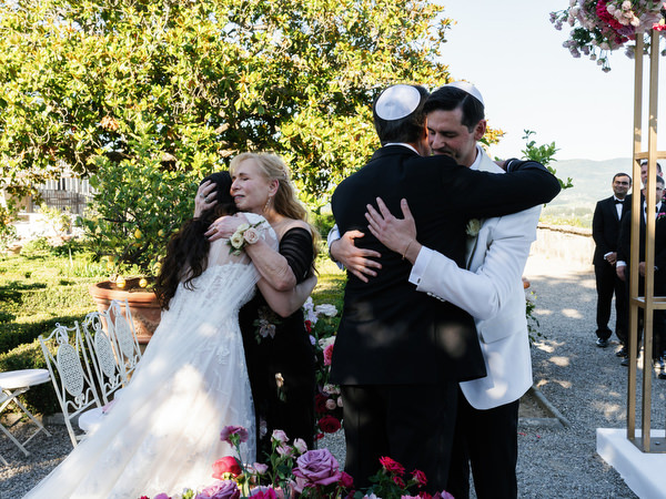 Family embrace under chuppah at Villa Corsini, meaningful Jewish wedding in Florence.