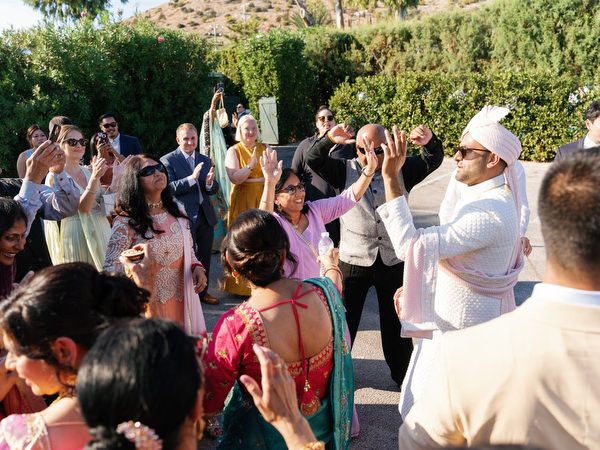 Family and friends dancing during the baraat procession at Island Resort the Residence