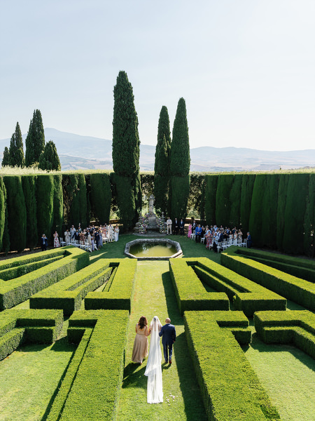 Wide view of garden ceremony at La Foce overlooking rolling hills of Tuscany