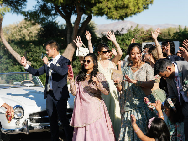 Guests raising their hands in celebration outside Island Resort the Residence on the Athens Riviera