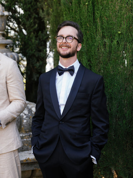 Close-up of groom smiling during emotional wedding ceremony in the Tuscan countryside