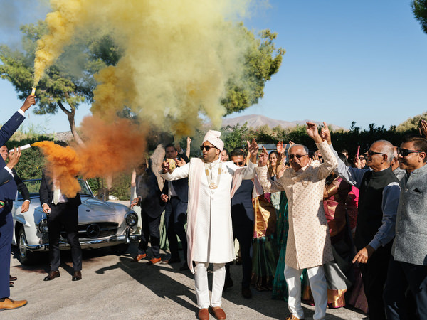 Groom leading the baraat with yellow smoke at Island Resort the Residence