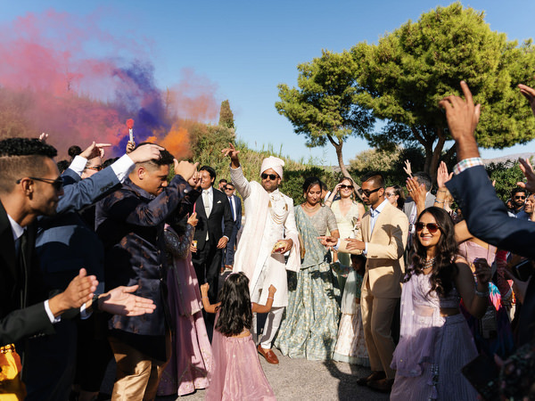 Guests dancing beneath orange and purple smoke during a three-day Indian wedding at Island Resort the Residence