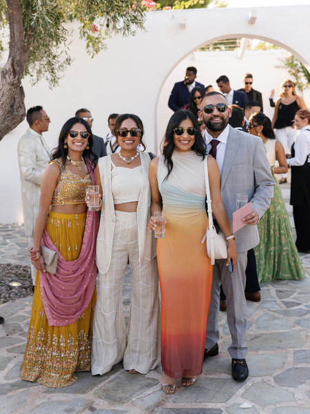 Guests arriving through white Mediterranean arches at Island Resort the Residence for an Indian destination wedding in Athens
