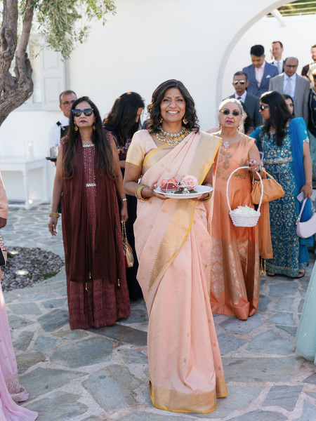 Family members walking into the ceremony space at Island Resort the Residence during an Athens Riviera Indian wedding