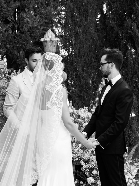 Black and white portrait of couple exchanging vows in Italian garden setting