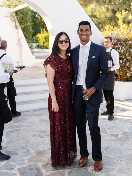 Couple posing beneath white arches at Island Resort the Residence on the Athens Riviera