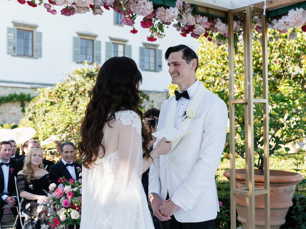 Groom during Jewish wedding ceremony under chuppah at Villa Corsini, Florence.