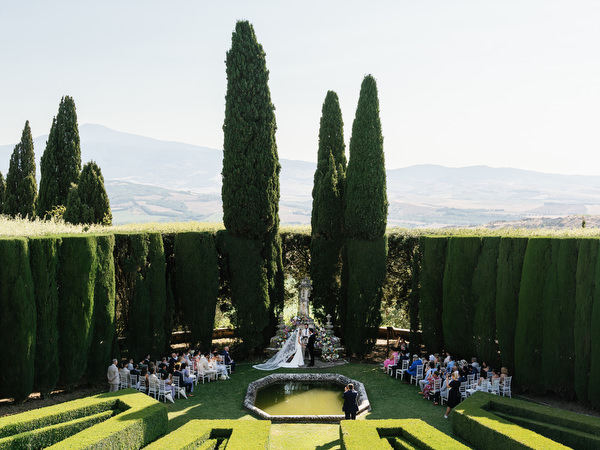 Symmetrical Renaissance garden ceremony at La Foce during destination wedding in Tuscany