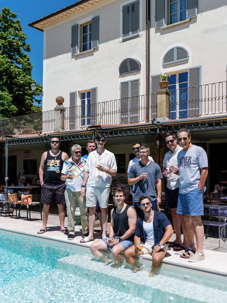Guests chatting poolside during Tuscany wedding weekend celebration