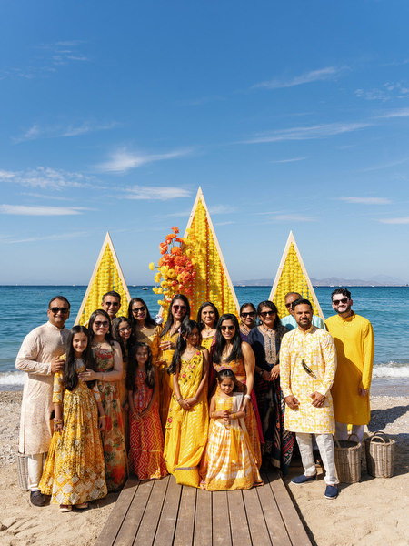 Yellow Haldi ceremony decor pyramids on beach in Athens