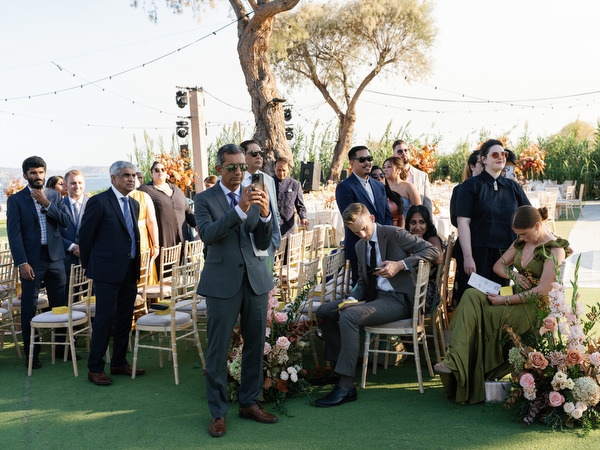 Guests seated along the floral-lined aisle at Island Resort the Residence during a Hindu wedding ceremony