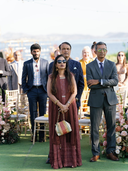 Guests standing during the ceremony at Island Resort the Residence overlooking the Athens Riviera