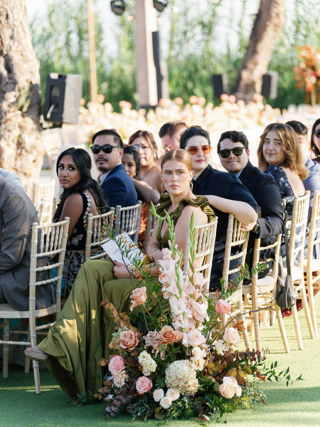 Ceremony guests seated beside floral arrangements at Island Resort the Residence on the Athens Riviera