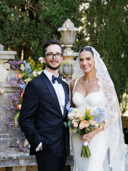 Elegant bride and groom portrait beneath cathedral veil during luxury Tuscany wedding