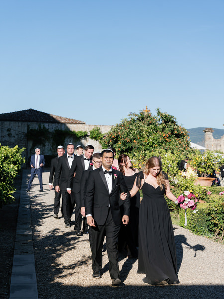 Wedding party walking through Villa Corsini gardens after Jewish ceremony in Florence, Tuscany.