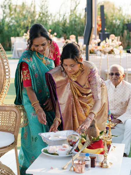 Family performing traditional Hindu wedding ritual at Island Resort the Residence during an Athens Riviera Indian wedding