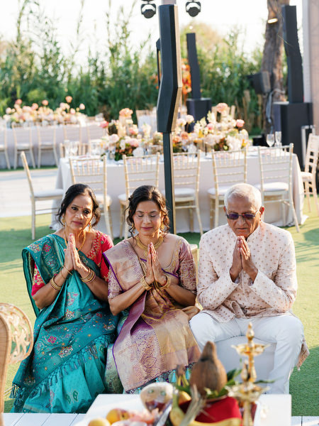 Family members praying during the Hindu ceremony at Island Resort the Residence on the Athens Riviera