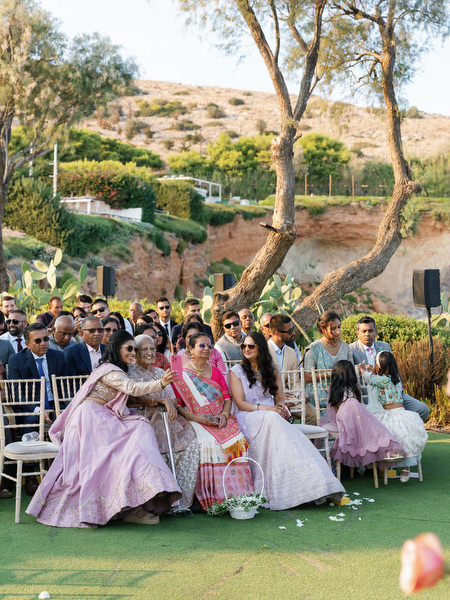Guests seated on the ceremony lawn overlooking the sea at Island Resort the Residence