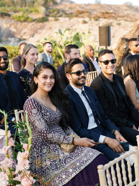 Guests seated beside floral aisle décor at Island Resort the Residence during an Athens Riviera Indian wedding