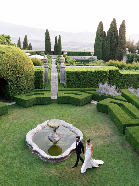Ornate fountain and symmetrical hedge gardens at La Foce estate in the Tuscan countryside